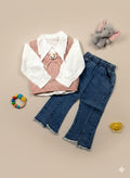 Children's outfit with shirt, inner, and jeans on a beige background